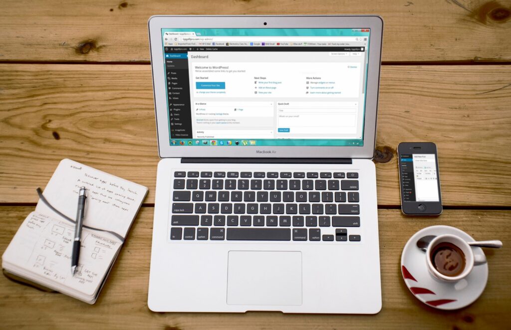 A laptop computer on a desk, showing a WordPress wp-admin page.